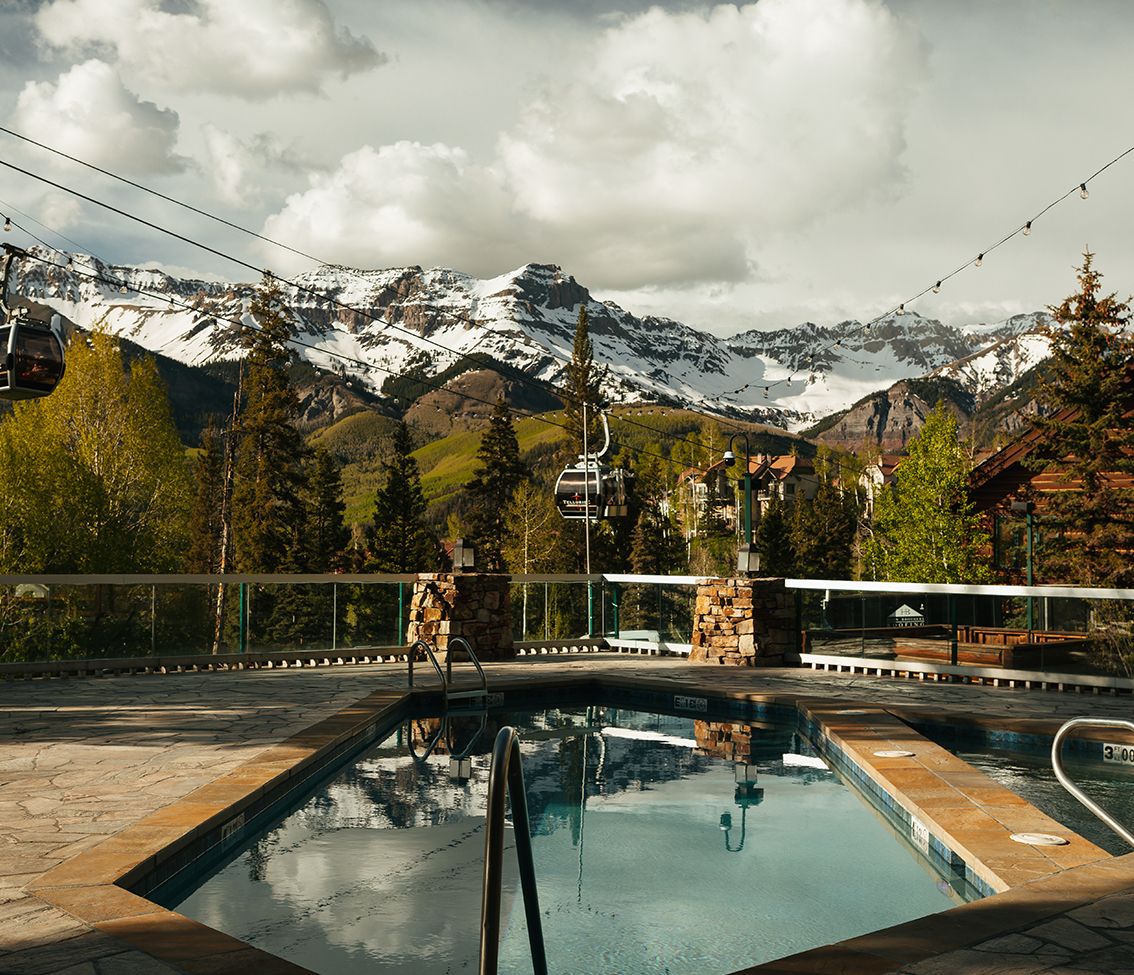 a pool with a mountain in the background