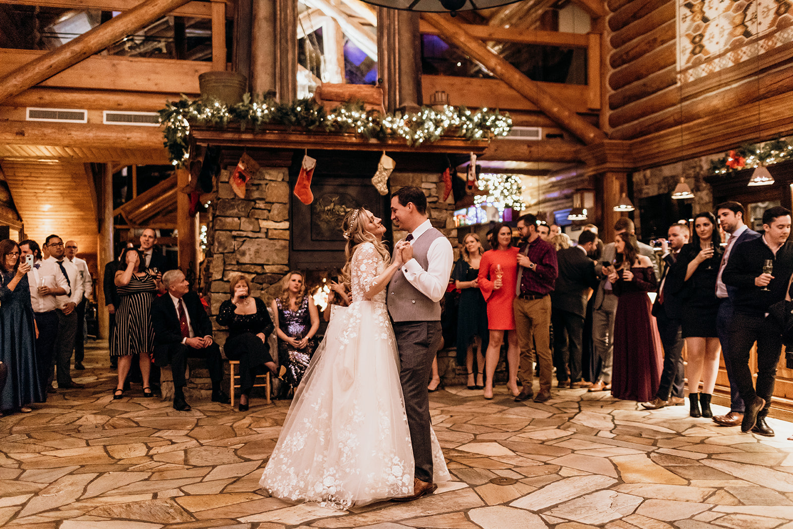a man and woman dancing in a room with a crowd watching