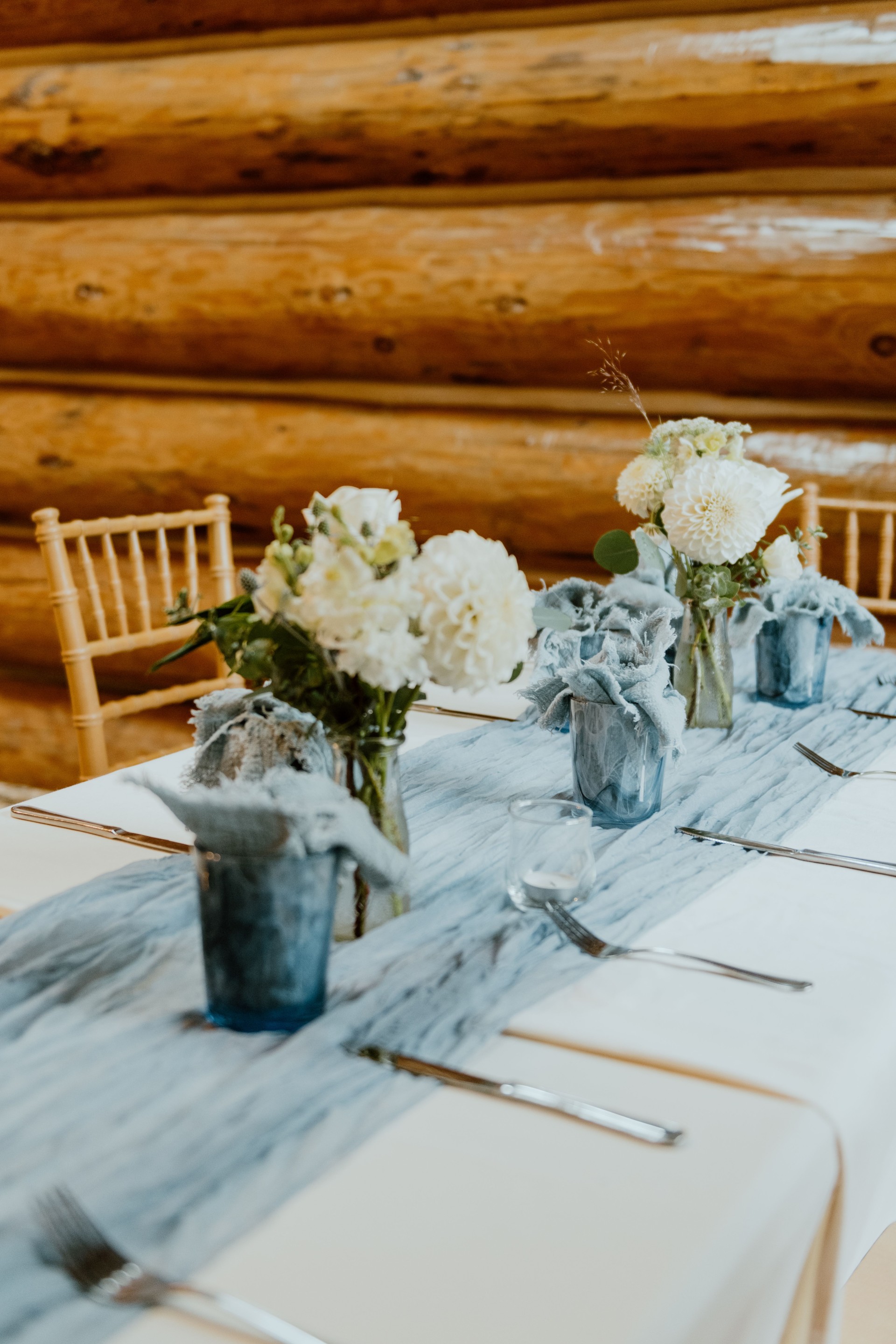 a table with flowers and silverware