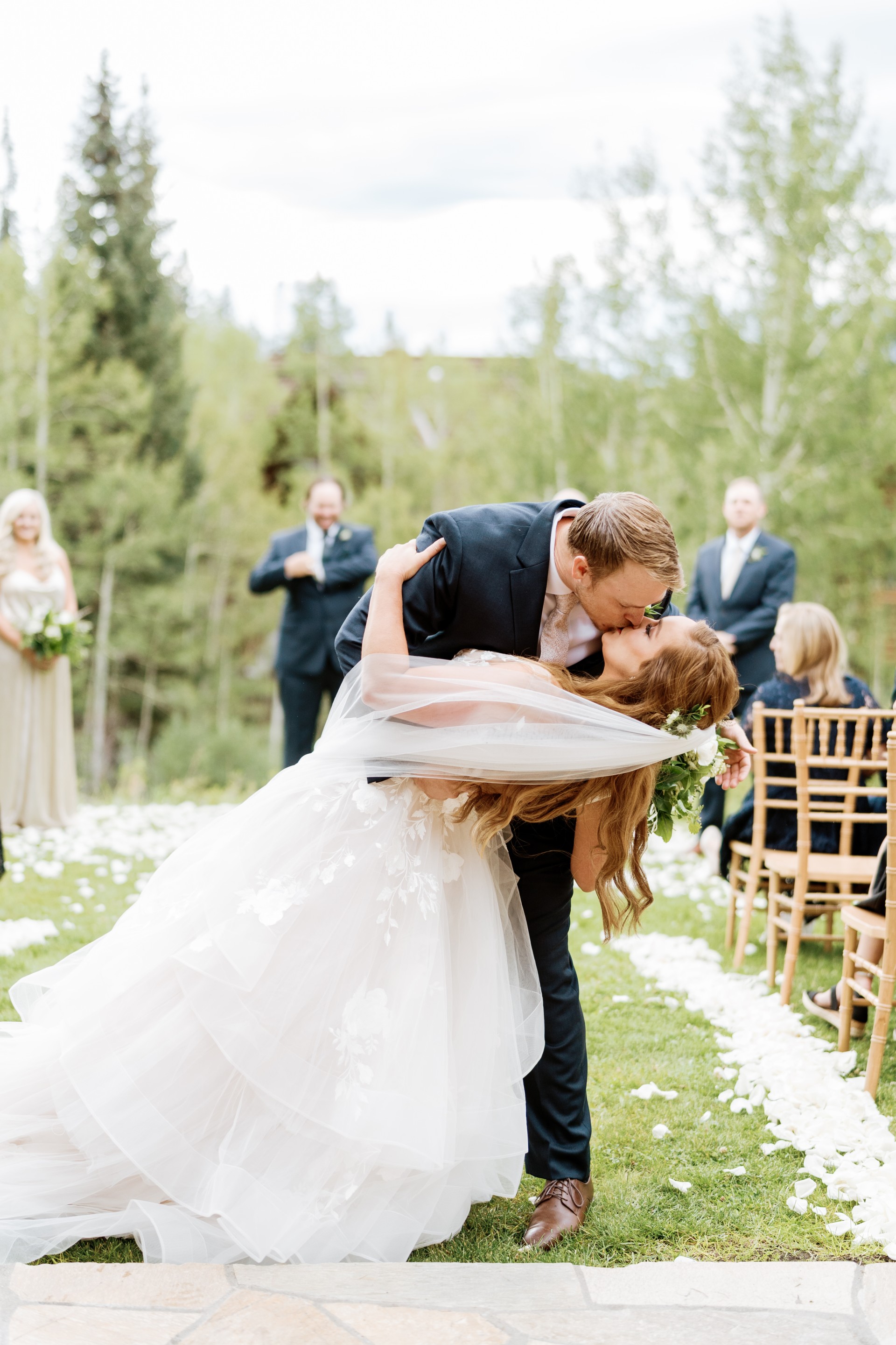 a man and woman kissing outside