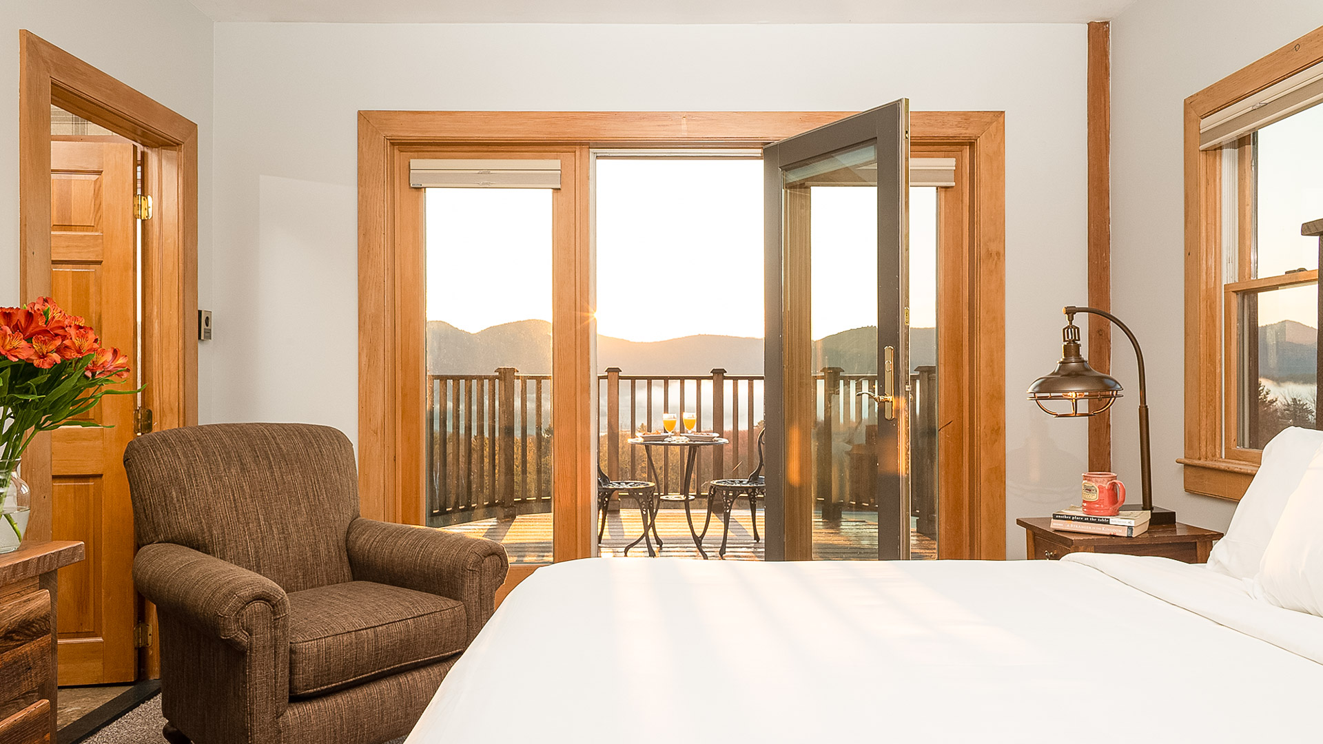 a room with a bed and a chair and a table with chairs and a table with chairs