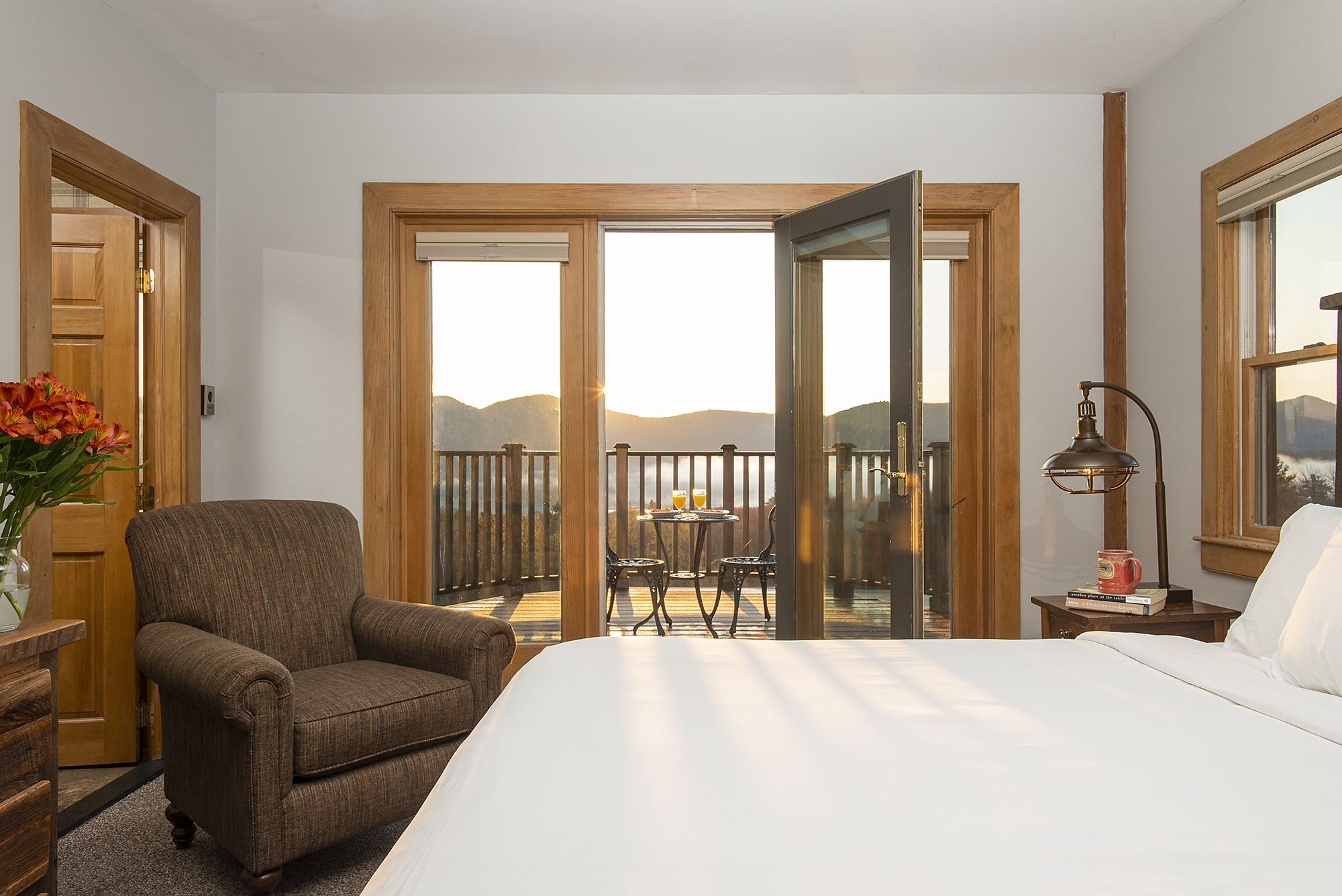 a bedroom with a bed and a chair and a table