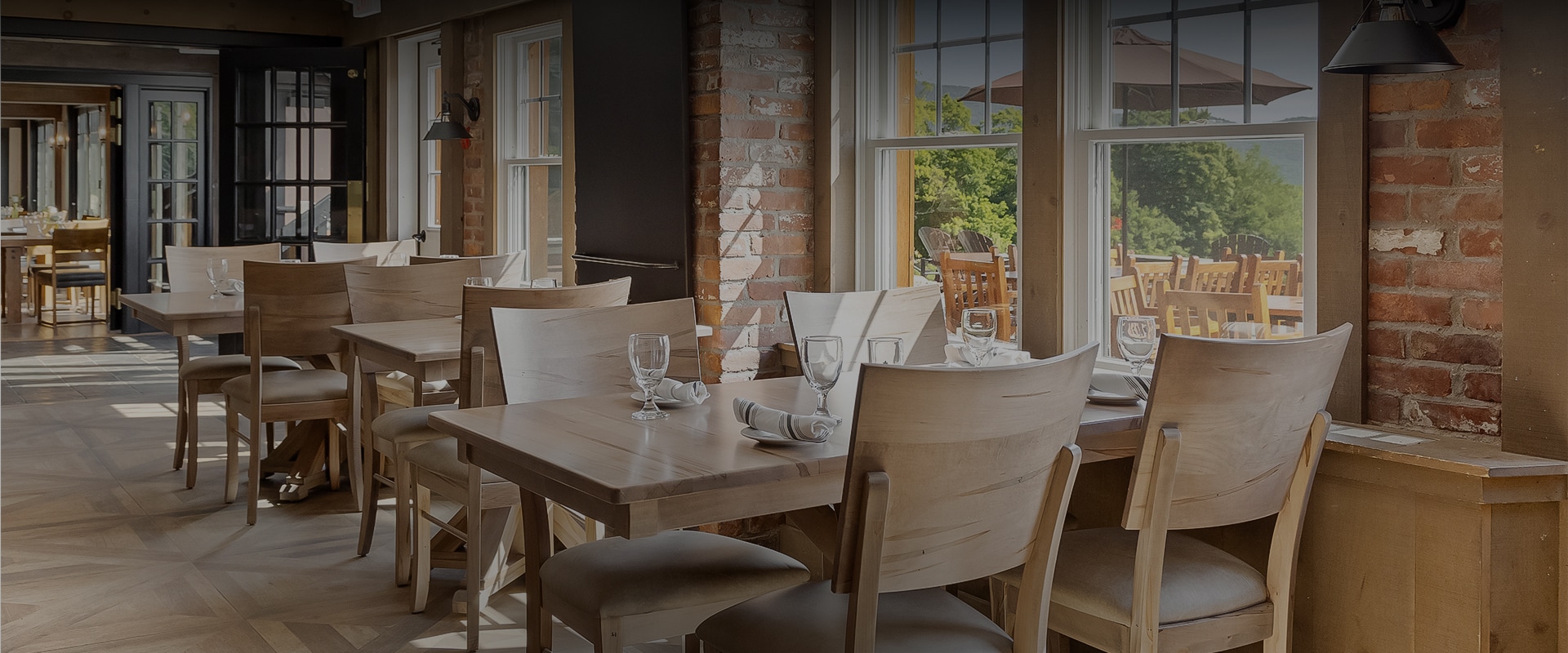 a table with chairs and glasses in a restaurant