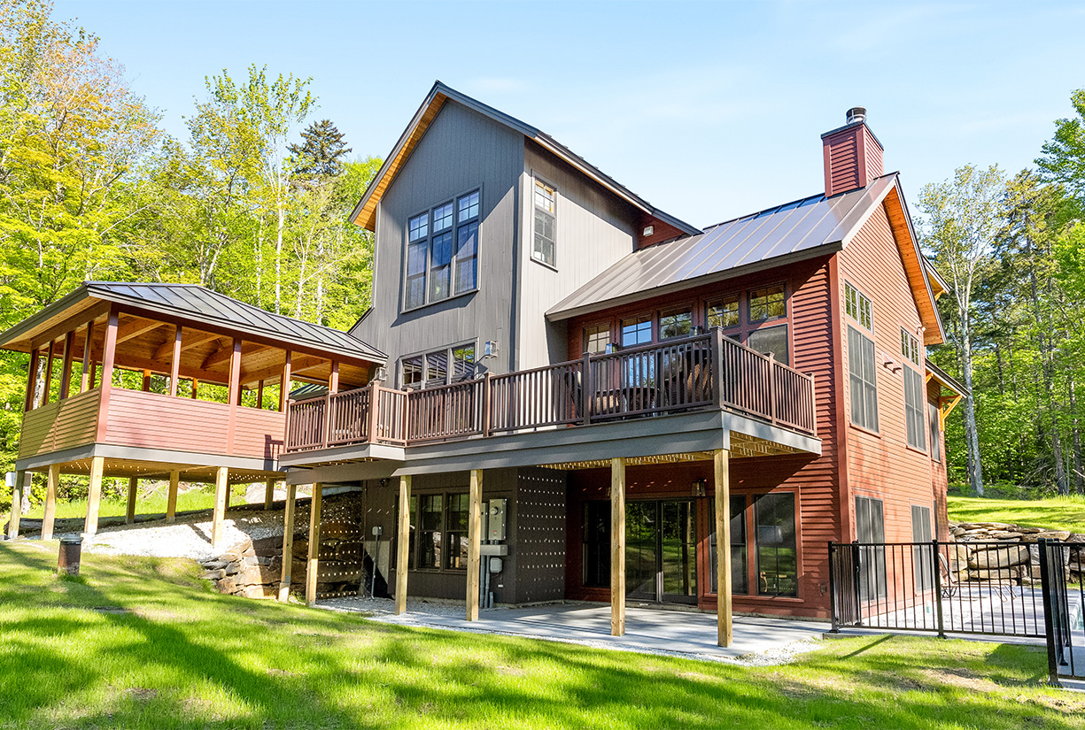 a large house with a deck and a porch