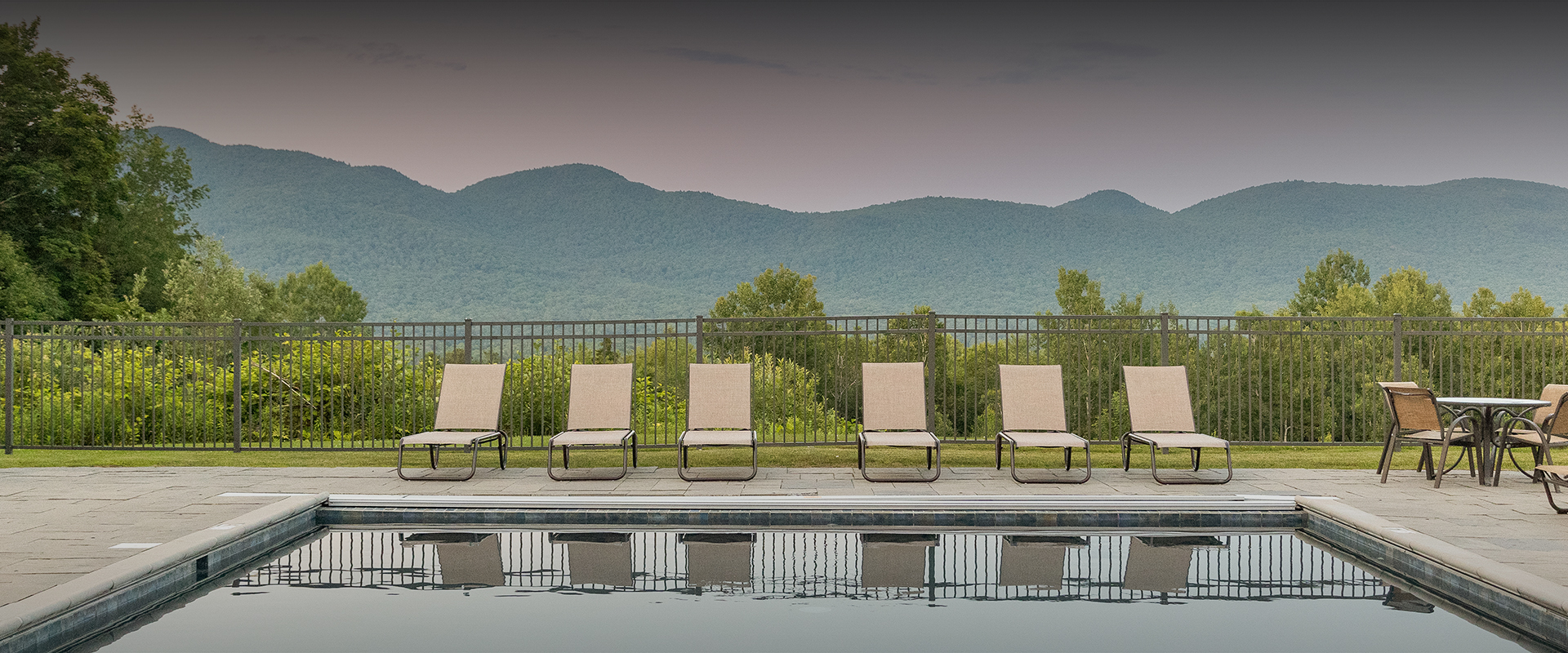 a row of chairs next to a pool