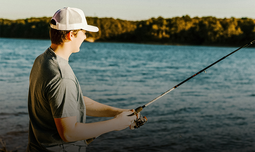 a man holding a fishing pole