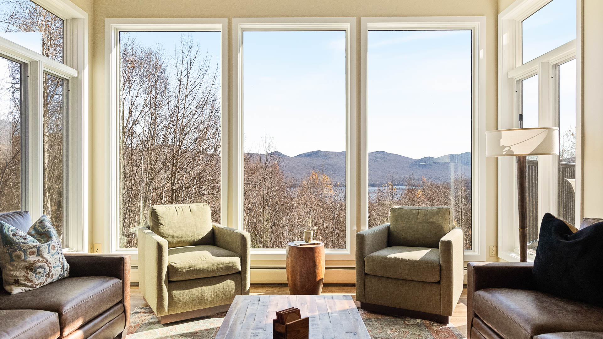 a room with a view of the mountains and trees