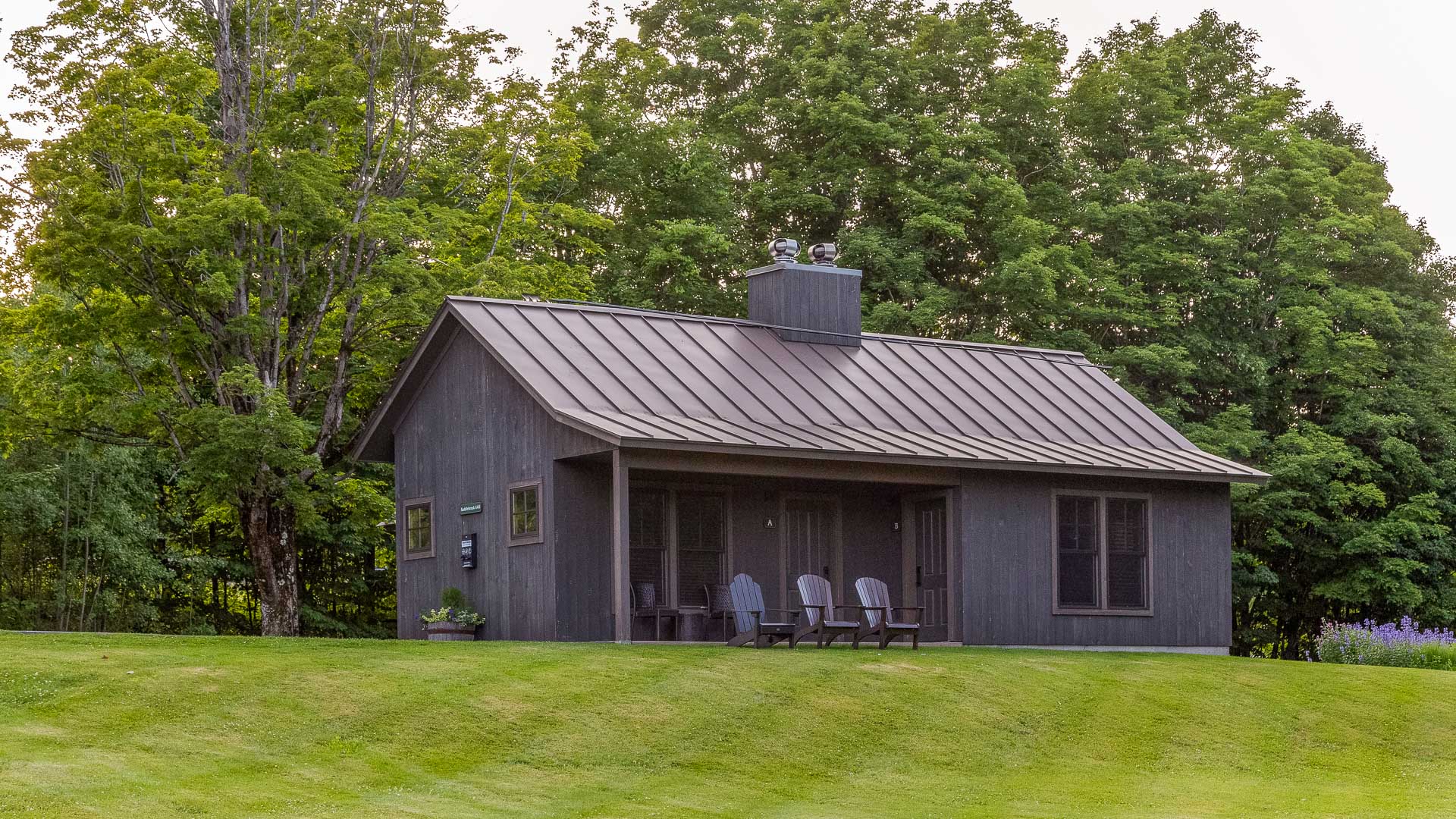 a house with chairs on the lawn