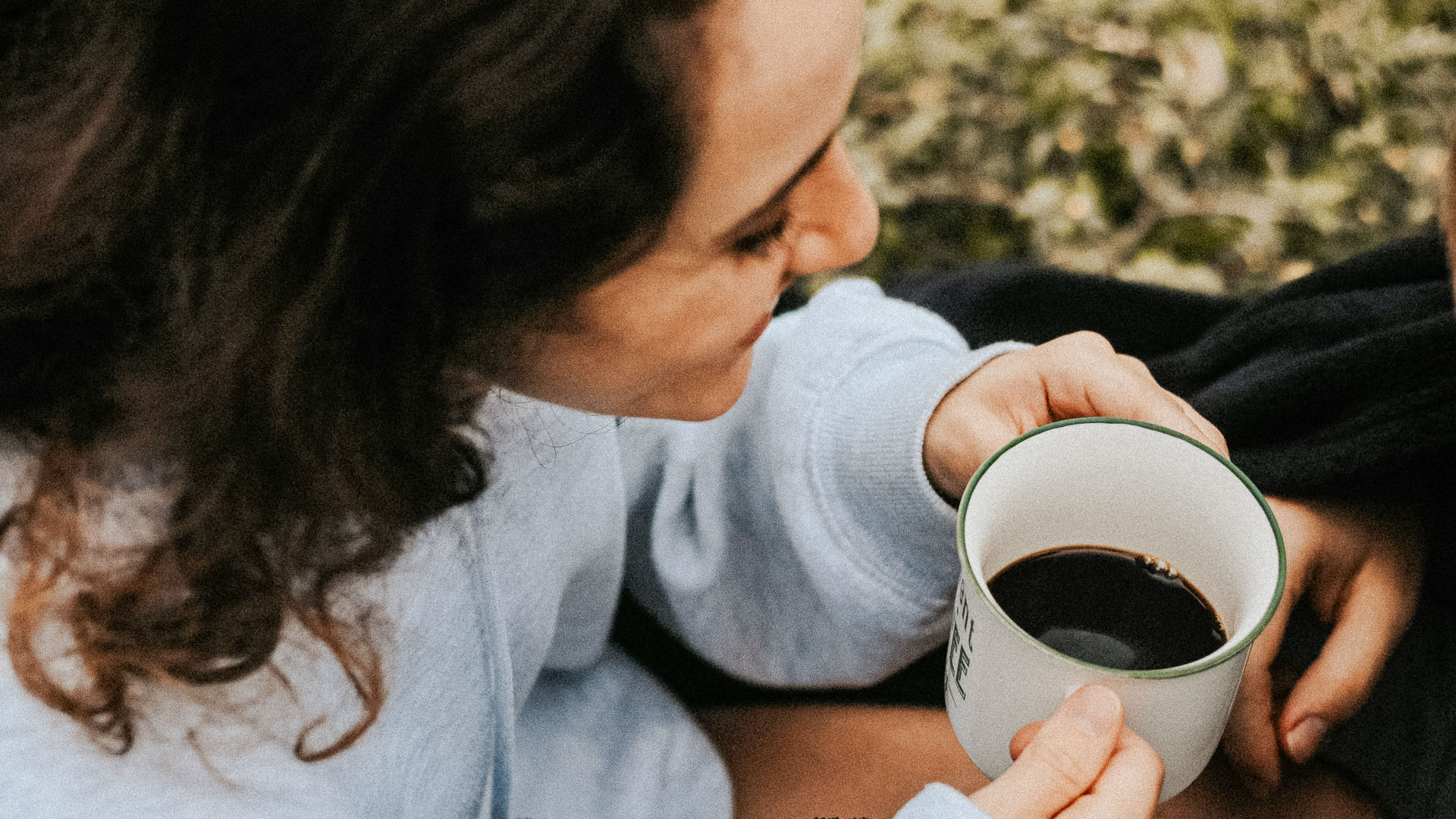 a woman holding a cup of coffee