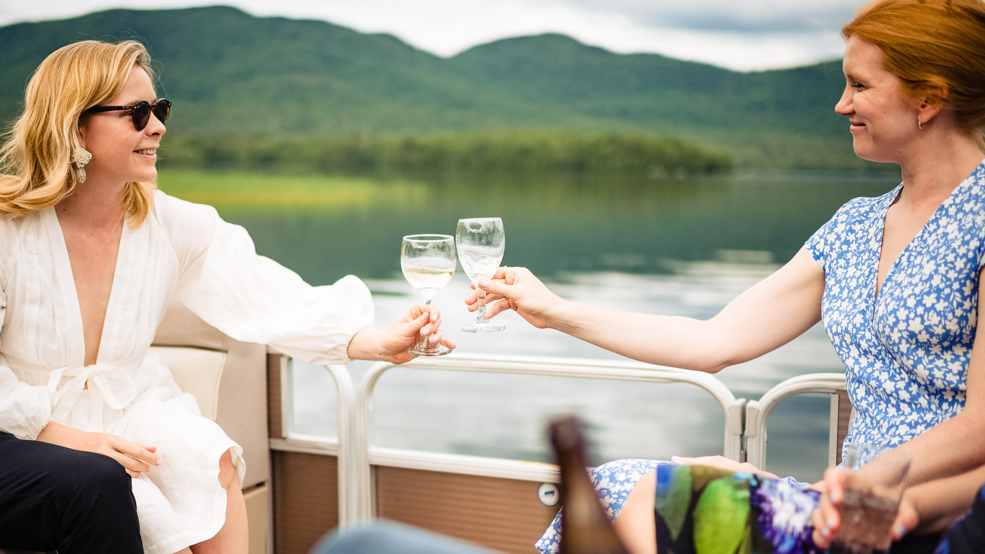 a group of people holding wine glasses on a boat