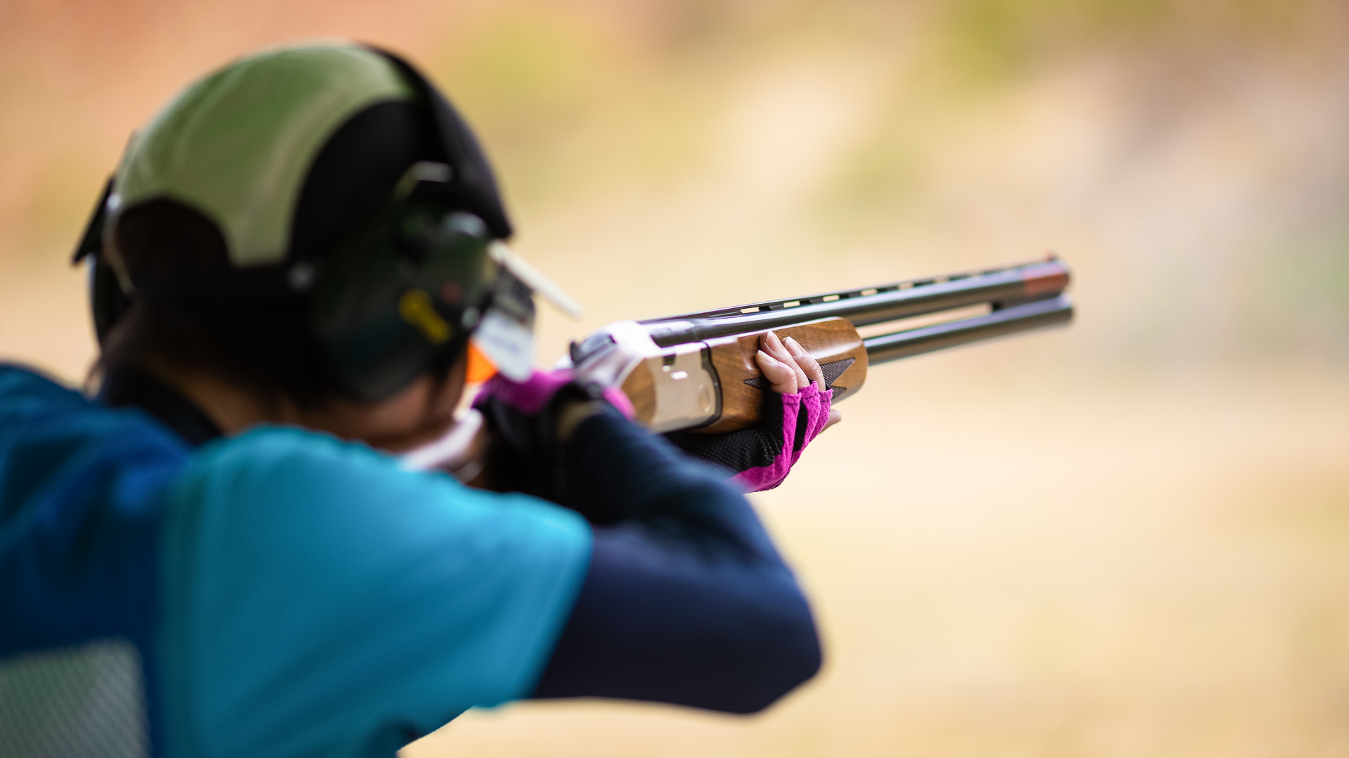 a person aiming a gun