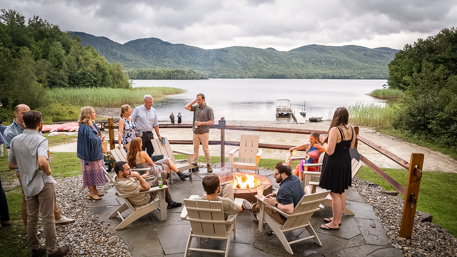 a group of people around a fire pit