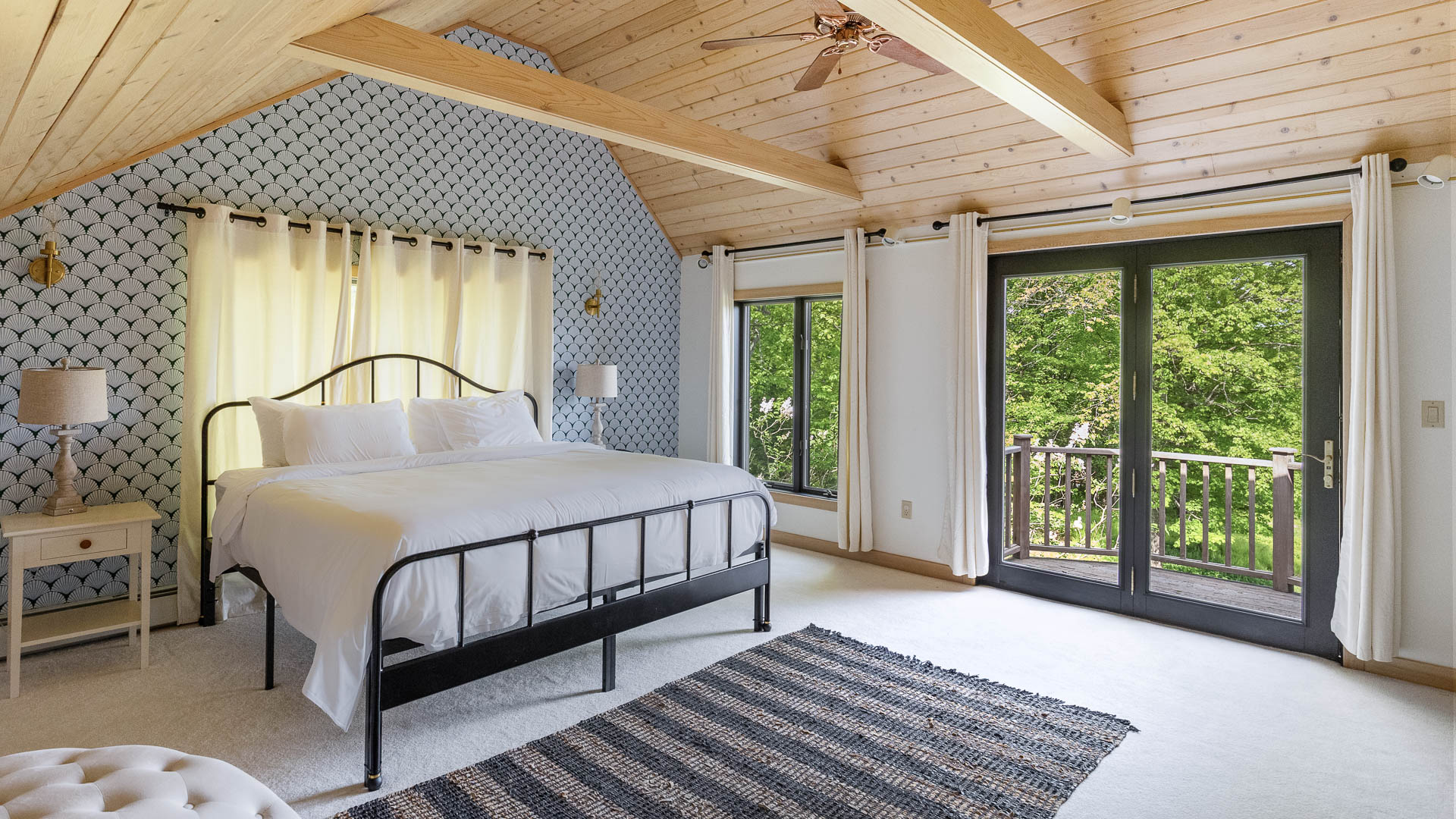 a bedroom with a bed and a rug