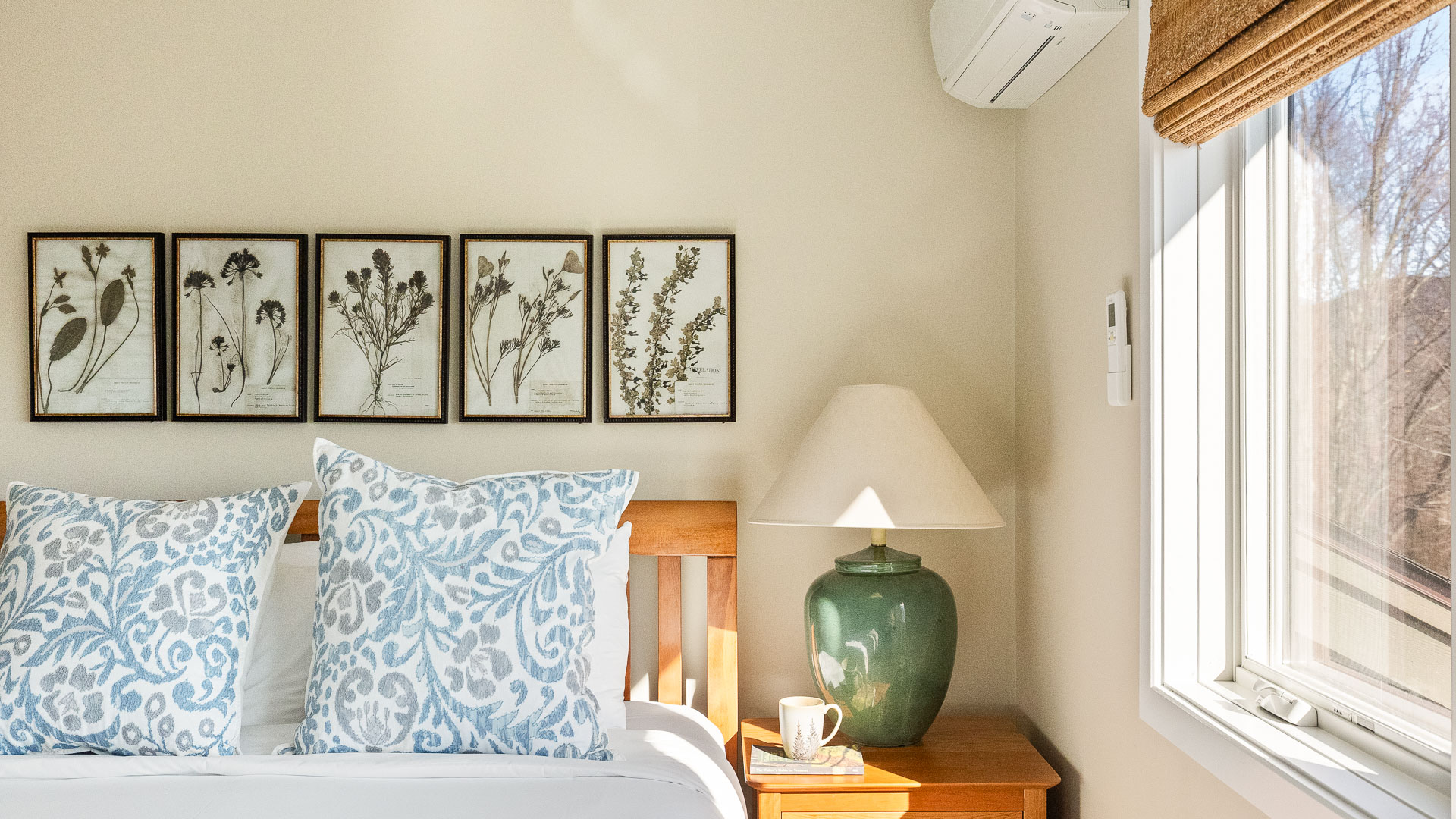 a bed with a lamp and a coffee cup