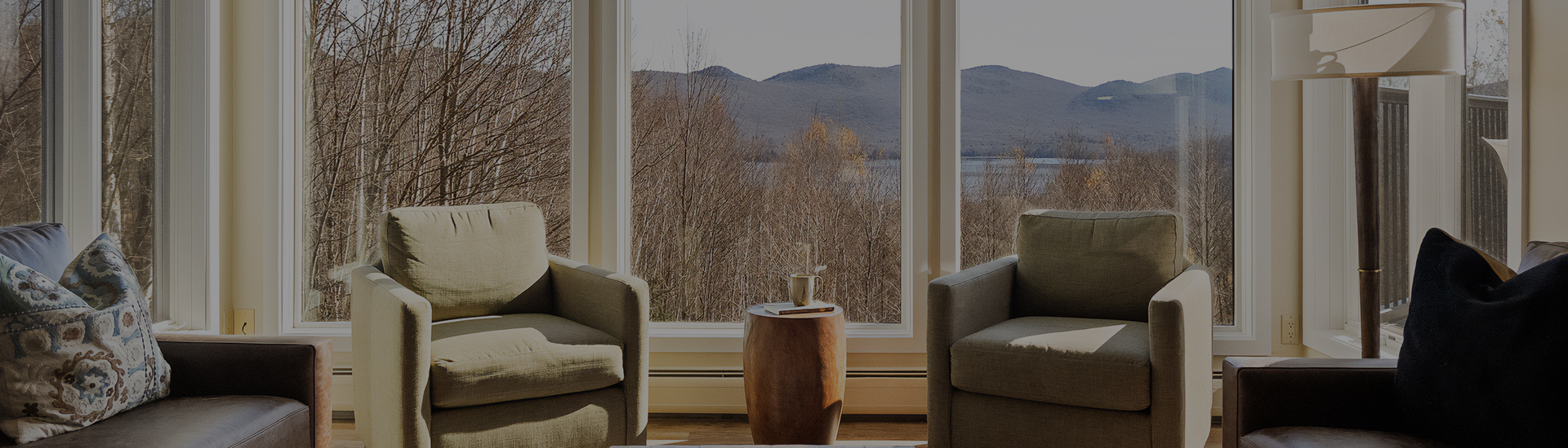 a table with a cup on it next to a window