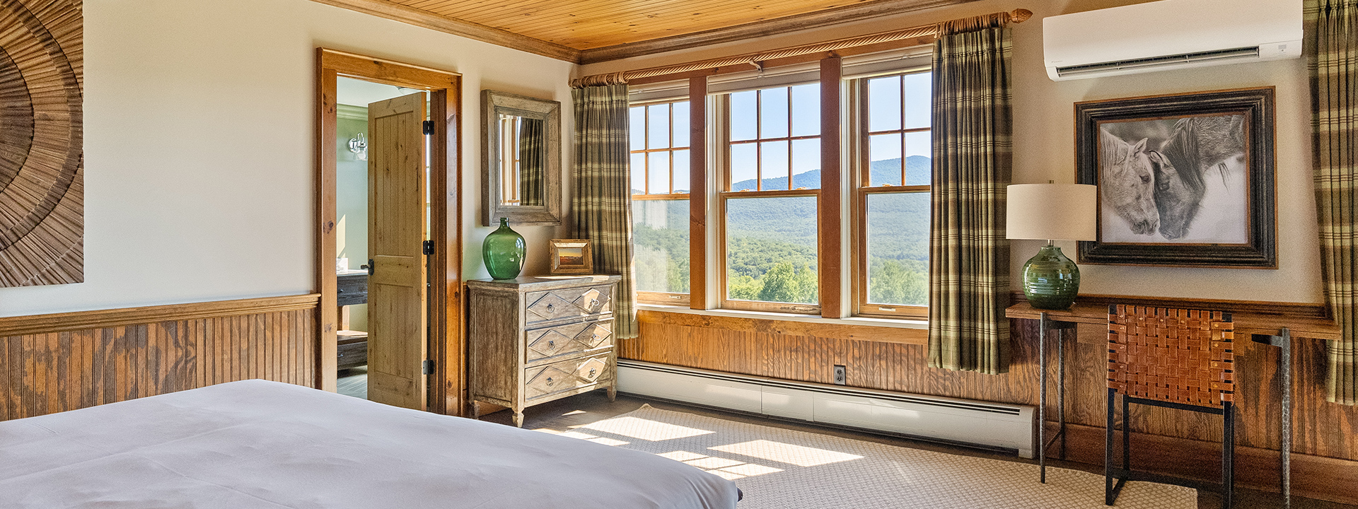 a bedroom with a dresser and a mirror