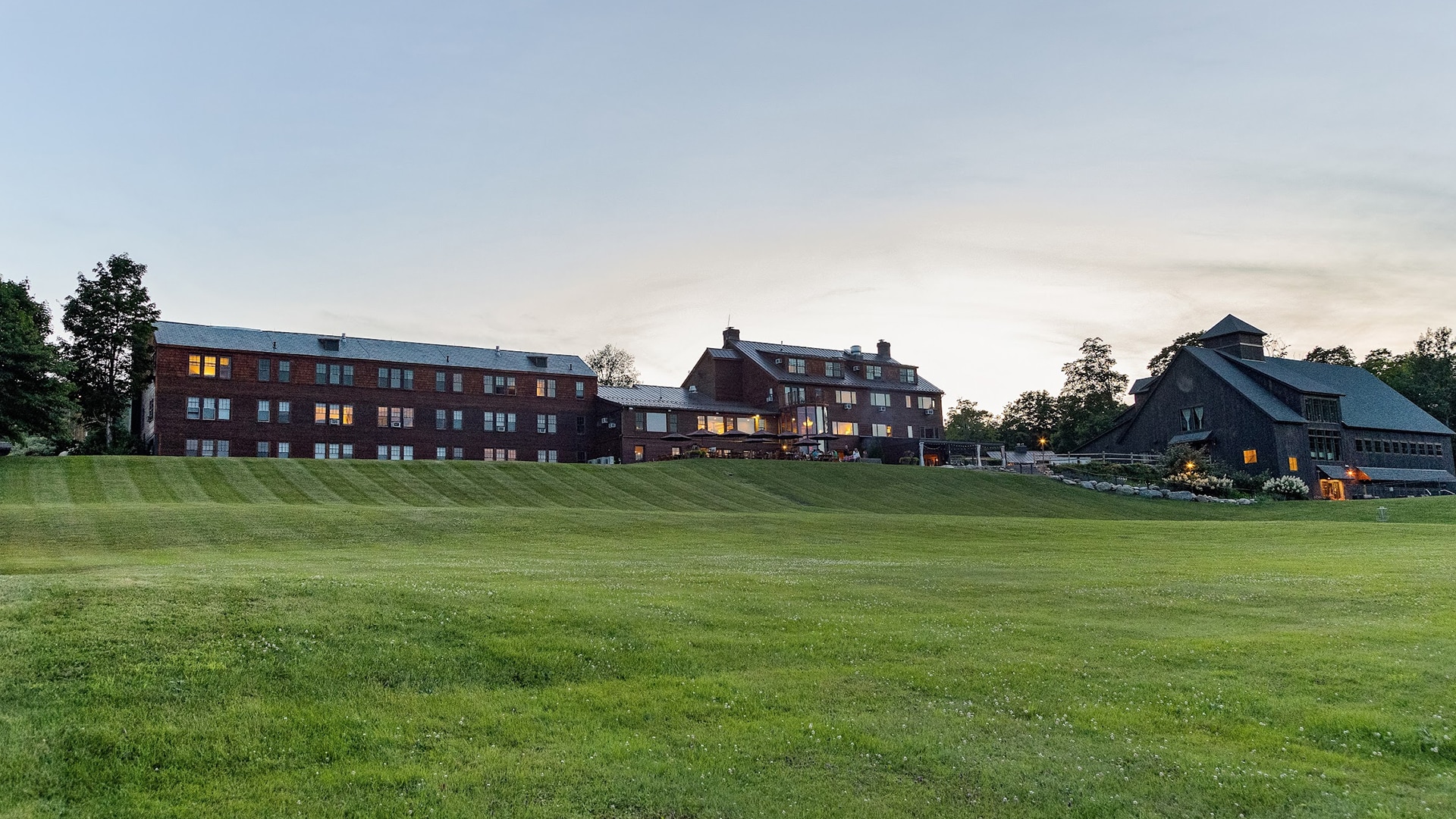 a large lawn with a building in the background