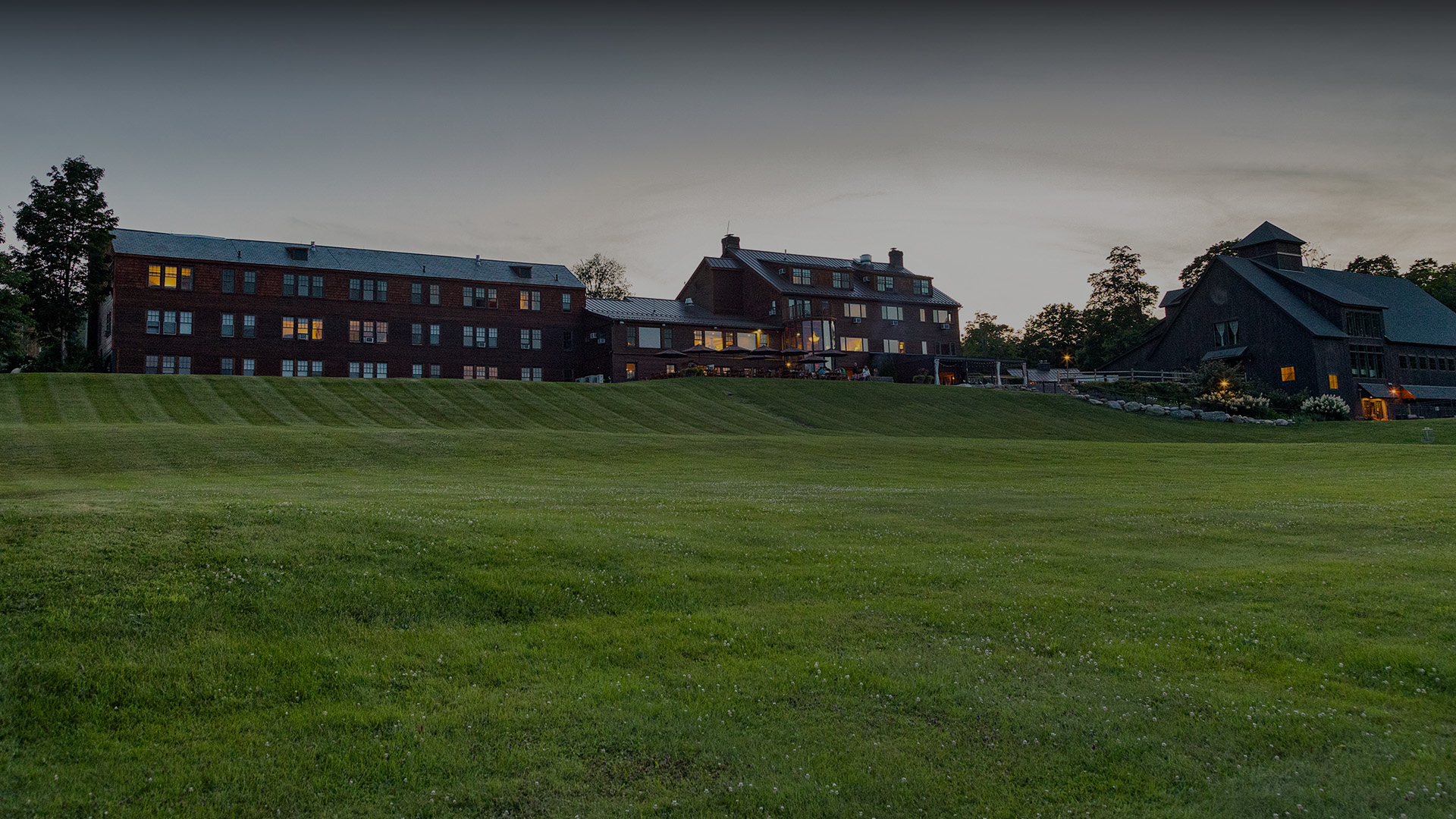a large lawn with a building in the background