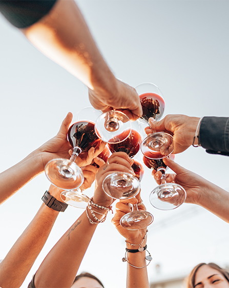a group of people holding wine glasses