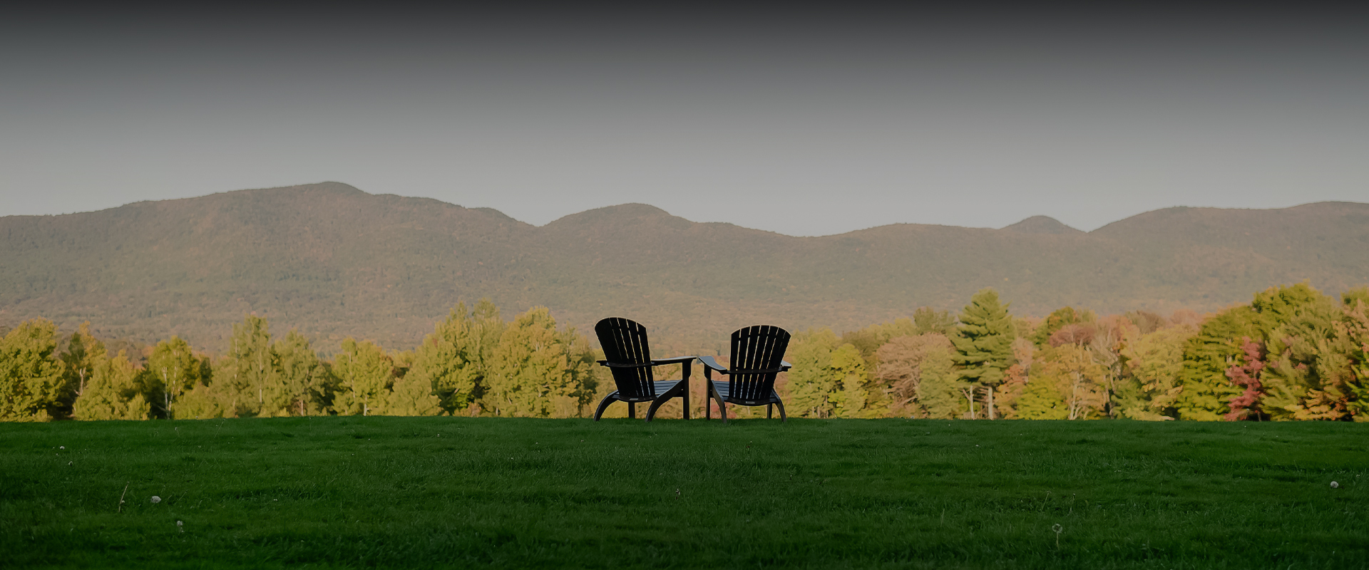 two chairs on a grassy hill
