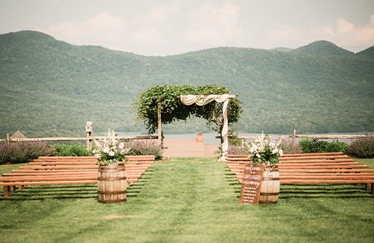 a wedding ceremony area with benches and chairs