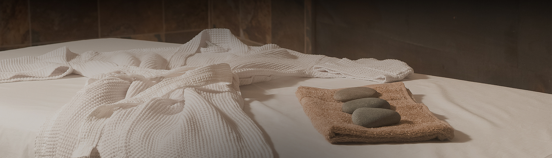a towel and stones on a table