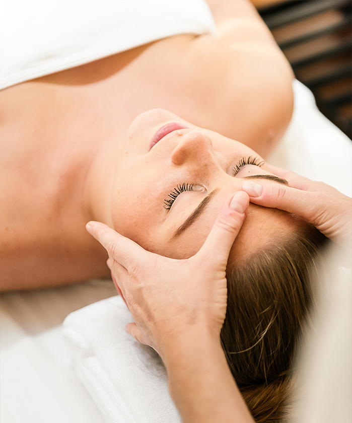 a woman lying down on a massage table