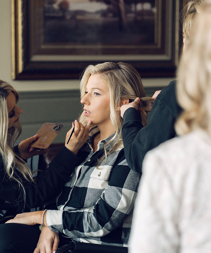 a woman getting her makeup done