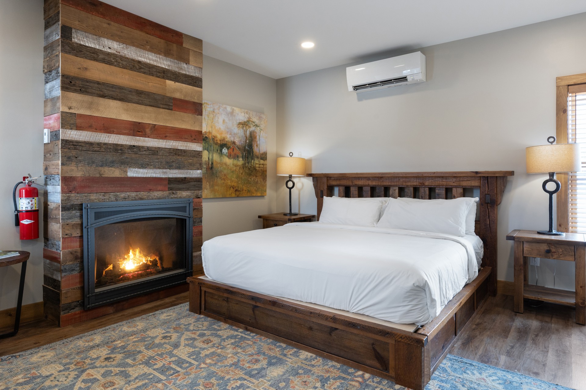 a bed with a fireplace in the background