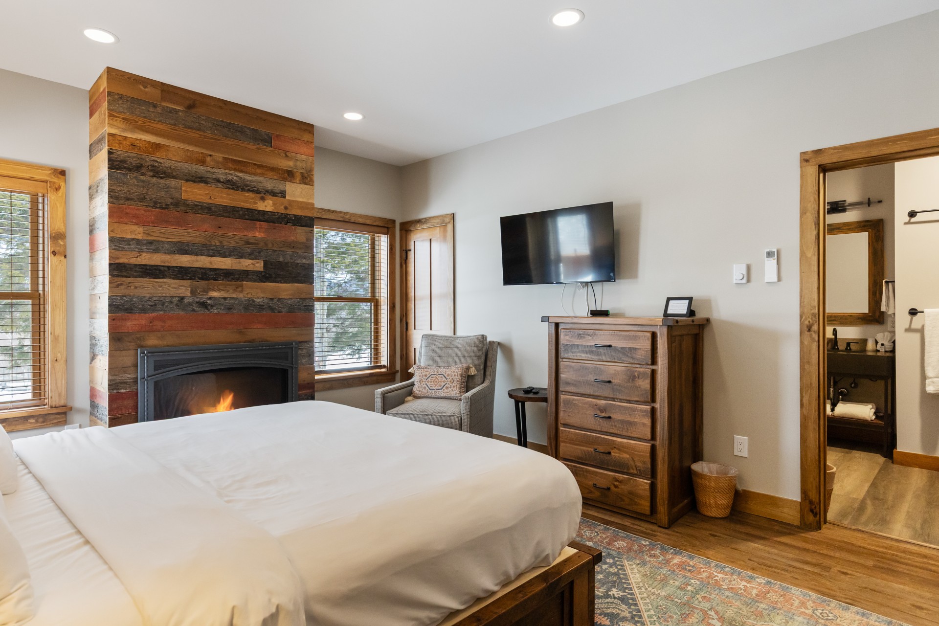 a bedroom with a fireplace and a bed