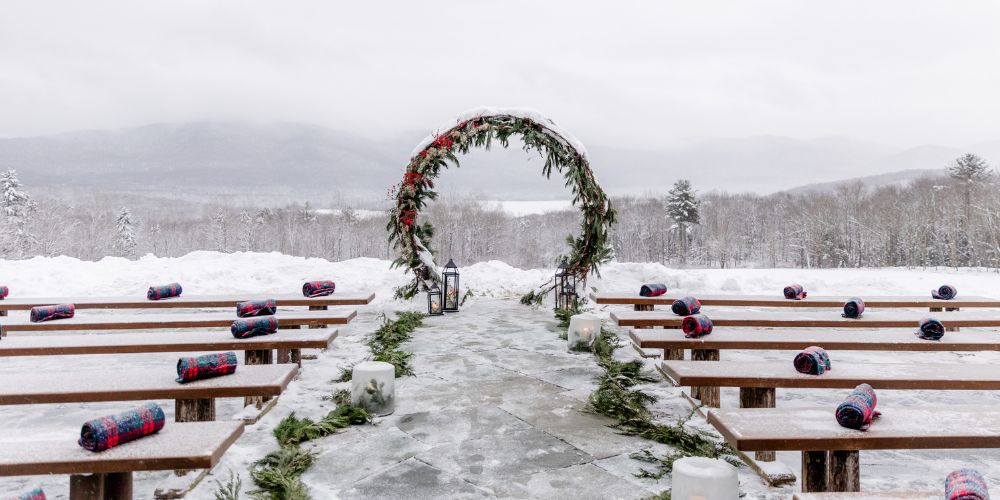 a snow covered arch and benches