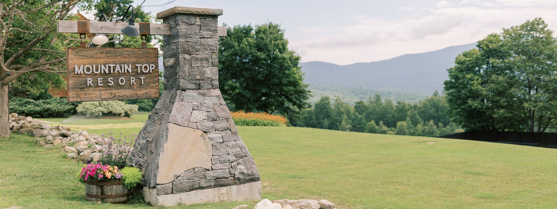 a stone chimney in a grassy area