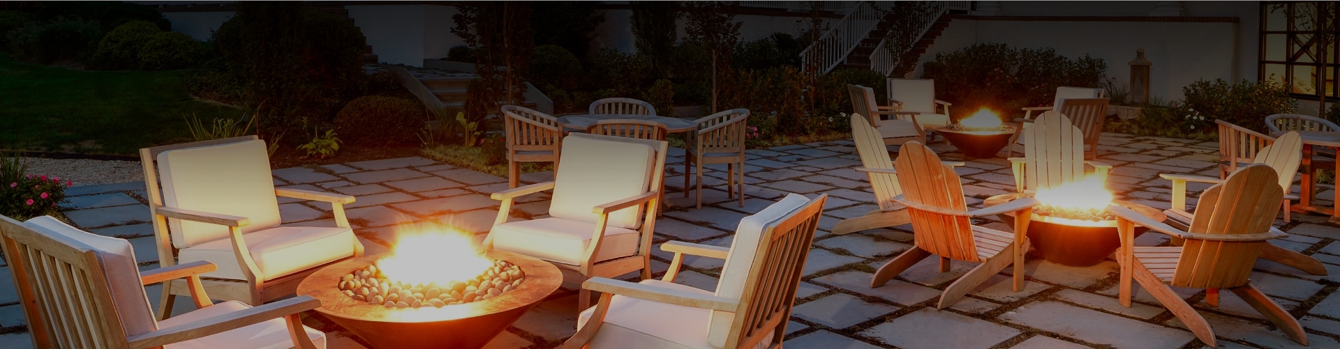 a patio with chairs and a fire pit