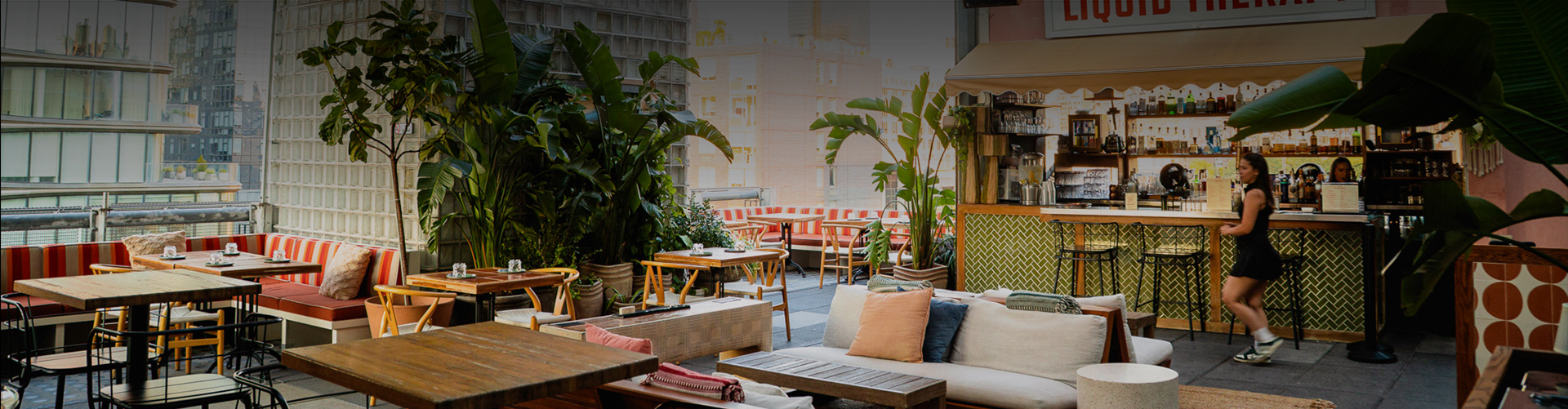 a patio with tables and chairs and plants