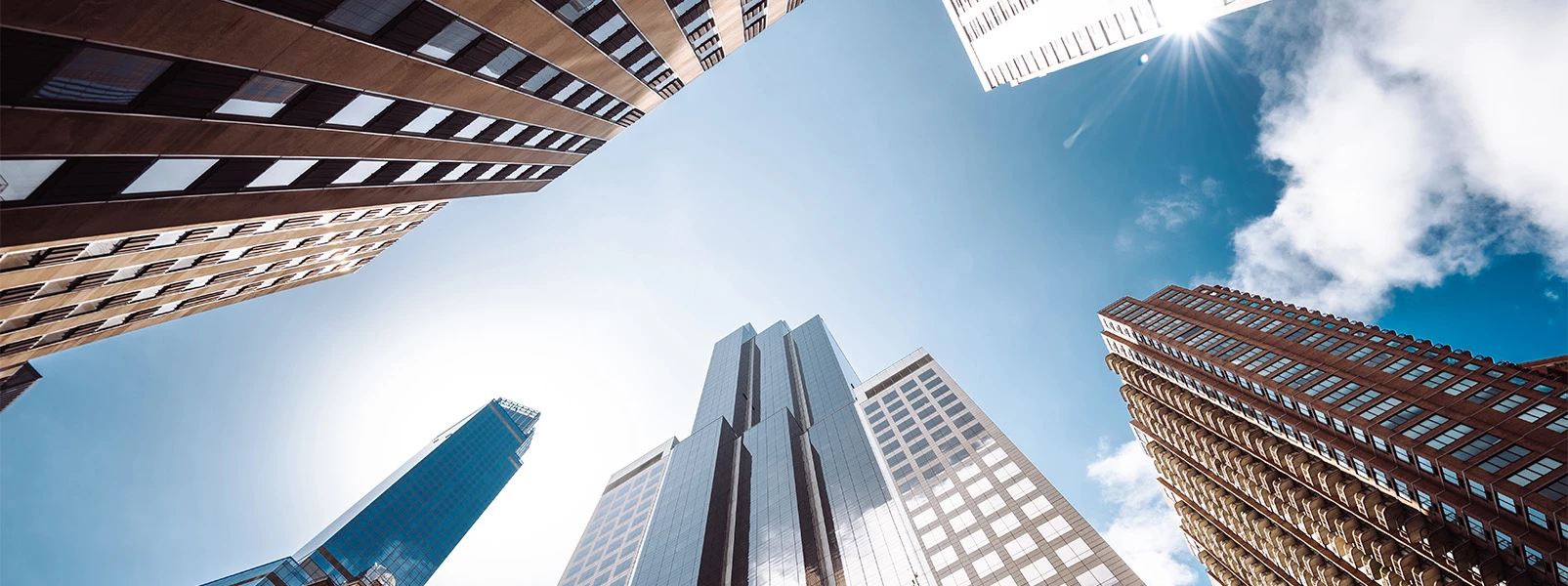 looking up view of a group of tall buildings