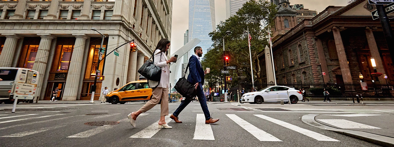 a man and woman crossing a street