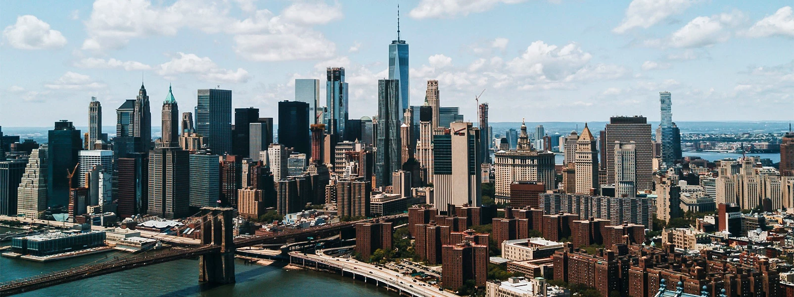 a city with many tall buildings and a bridge