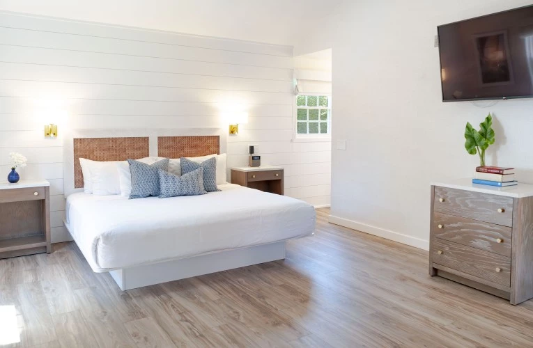 a bedroom with a bed and a wood floor