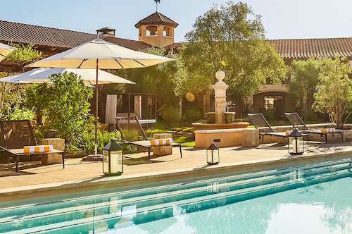 pool with lawn umbrellas and seating