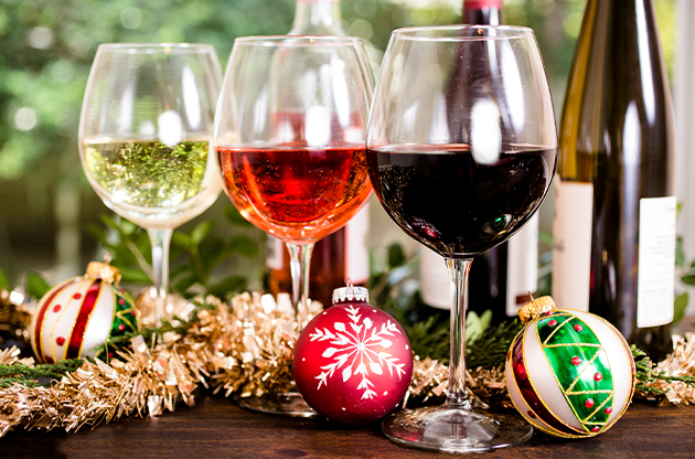 a group of wine glasses with ornaments and tinsel