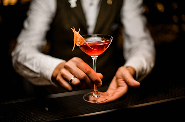 a person holding a glass of drink