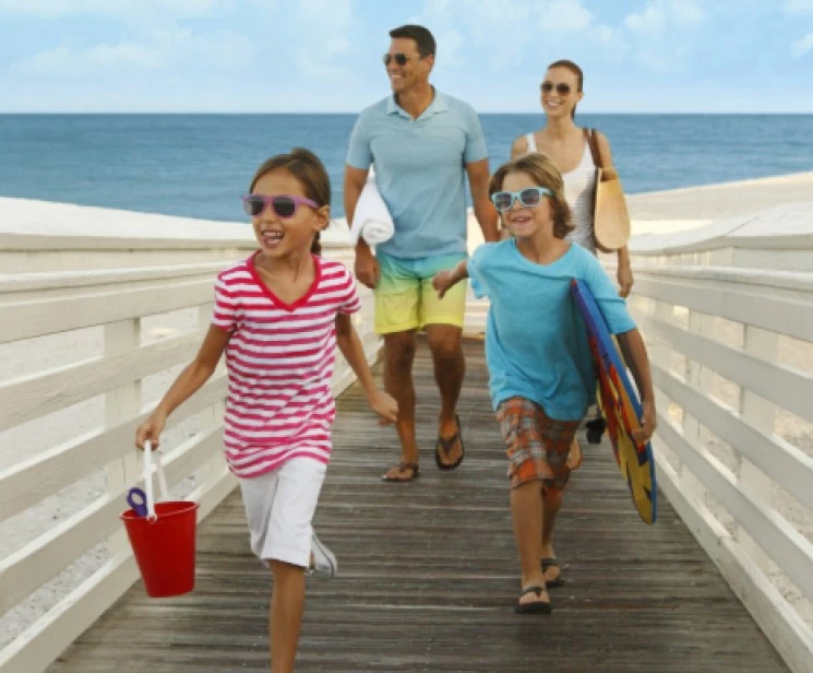 a family walking on a boardwalk