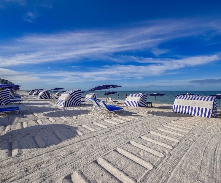 a beach with umbrellas and chairs