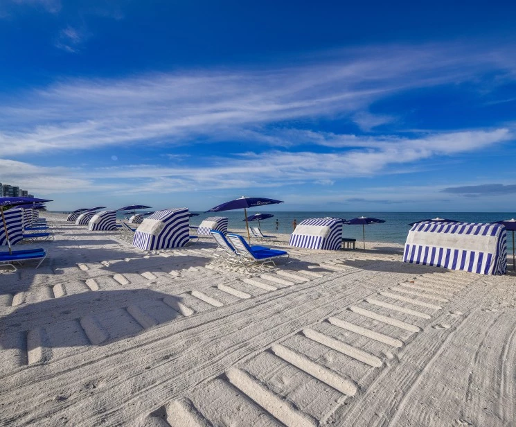 a beach with umbrellas and chairs