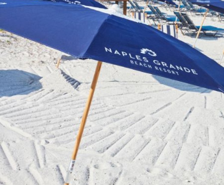 a group of blue umbrellas on a beach