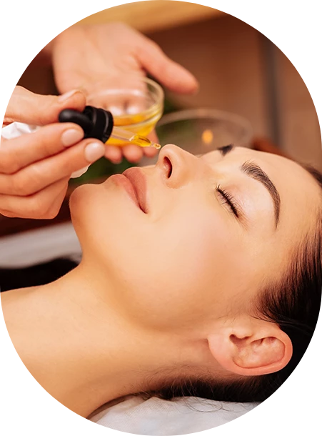 a woman receiving a facial oil