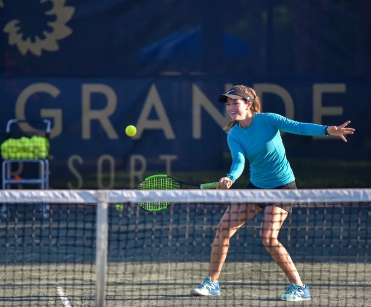 a woman playing tennis on a court