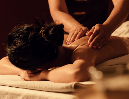 a woman lying down on a towel with her head on her face