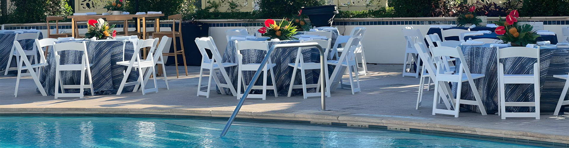 a pool with chairs and tables