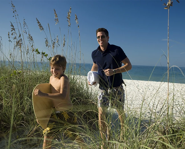 a man and boy on a beach